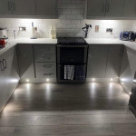 kickboard lighting in a white kitchen