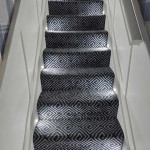 Patterned carpet with stair lights installed alternative sides