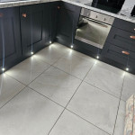 kitchen with rose gold hardware with kickboard lights