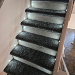wooden staircase with spotlights